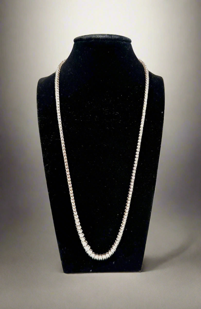 Diamond Necklace on a black velvet stand against a white background
