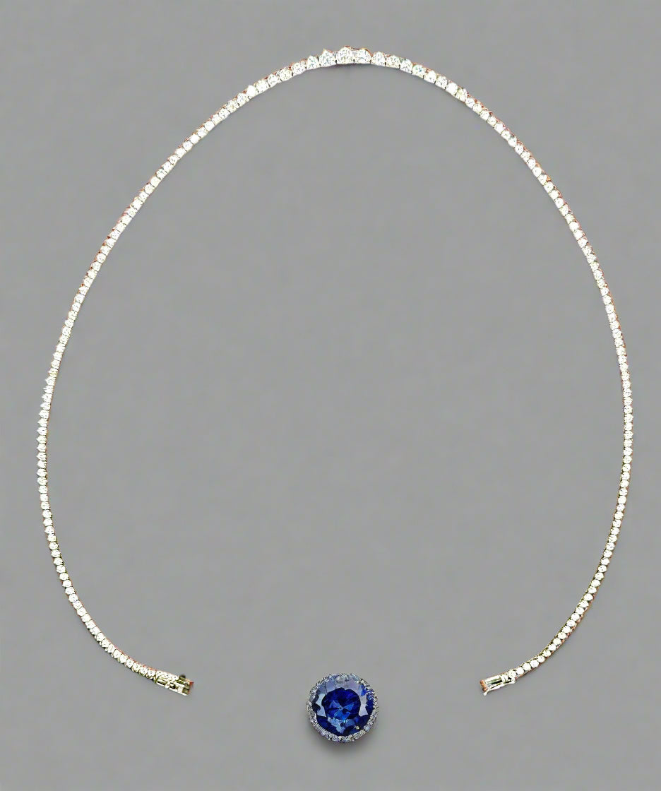 Silver beaded necklace on a gray background