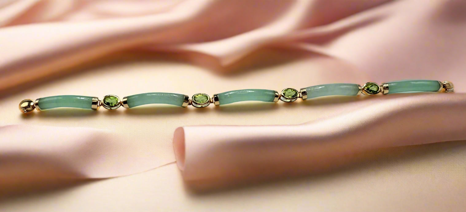 Jewelry bracelet with green stones on a light gray background