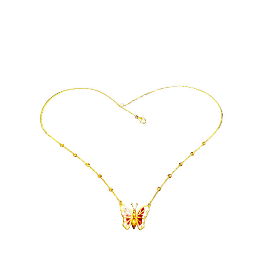 Gold necklace with a butterfly pendant on a gray background