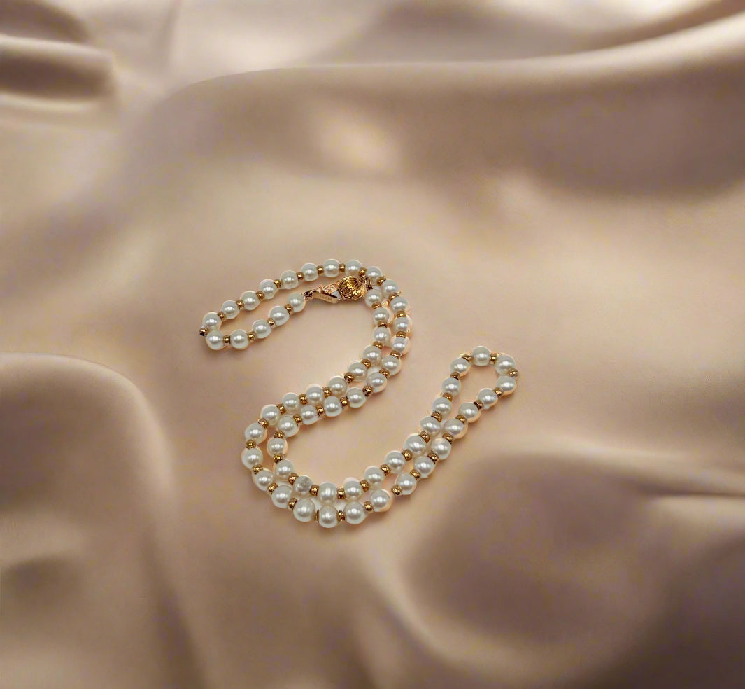 Pearl necklace on a light gray background