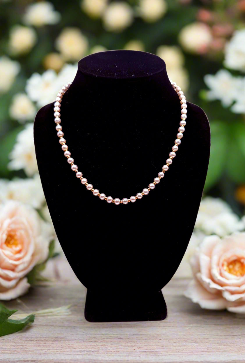 Pearl necklace on a black bust against a white background