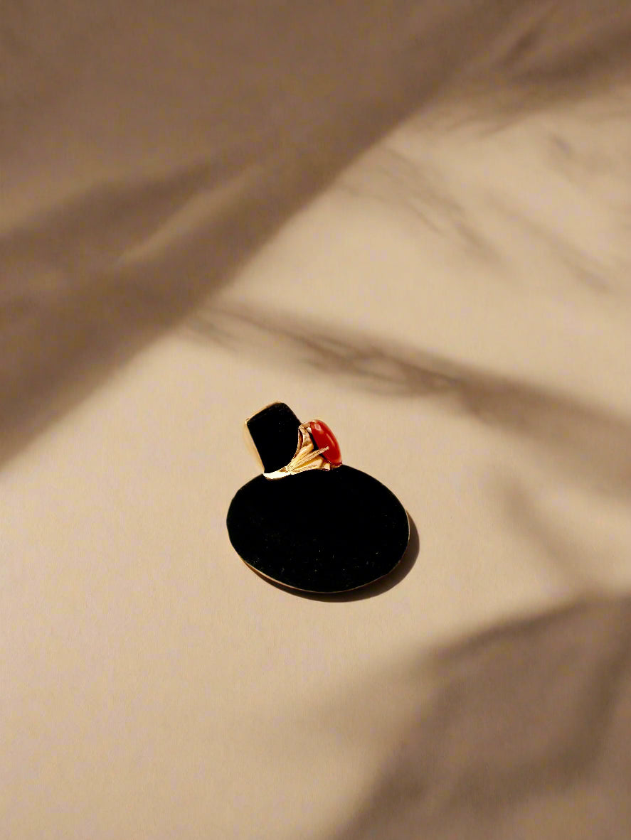 Black circular object with a person inside on a light gray background