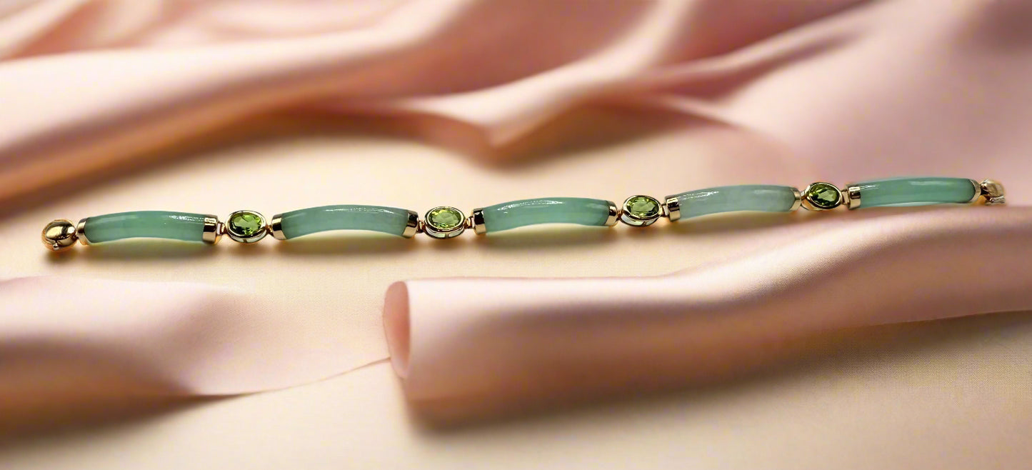 Jewelry bracelet with green stones on a light gray background