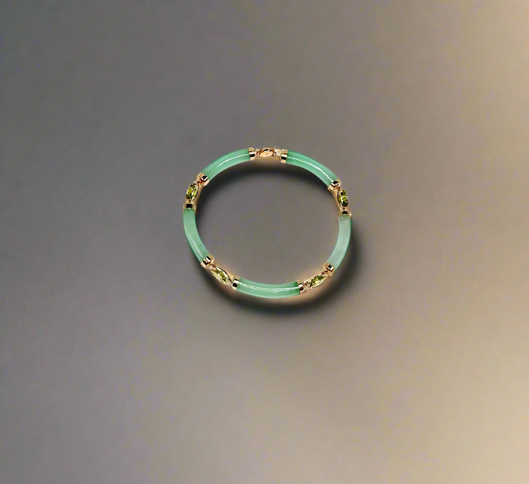Green bracelet with gold accents on a white background